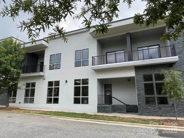 a view of building with a window and a tree