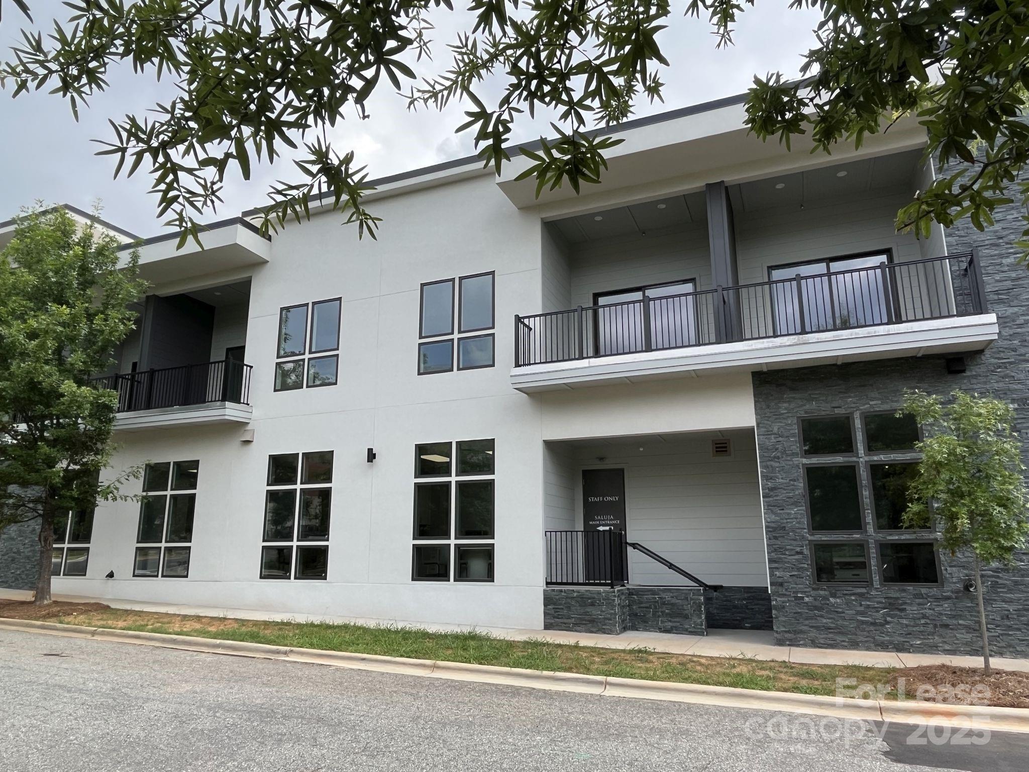 19546 Greentree Way, Unit 202 Cornelius, NC 28031 - Photo 1 of 30 a view of building with a window and a tree