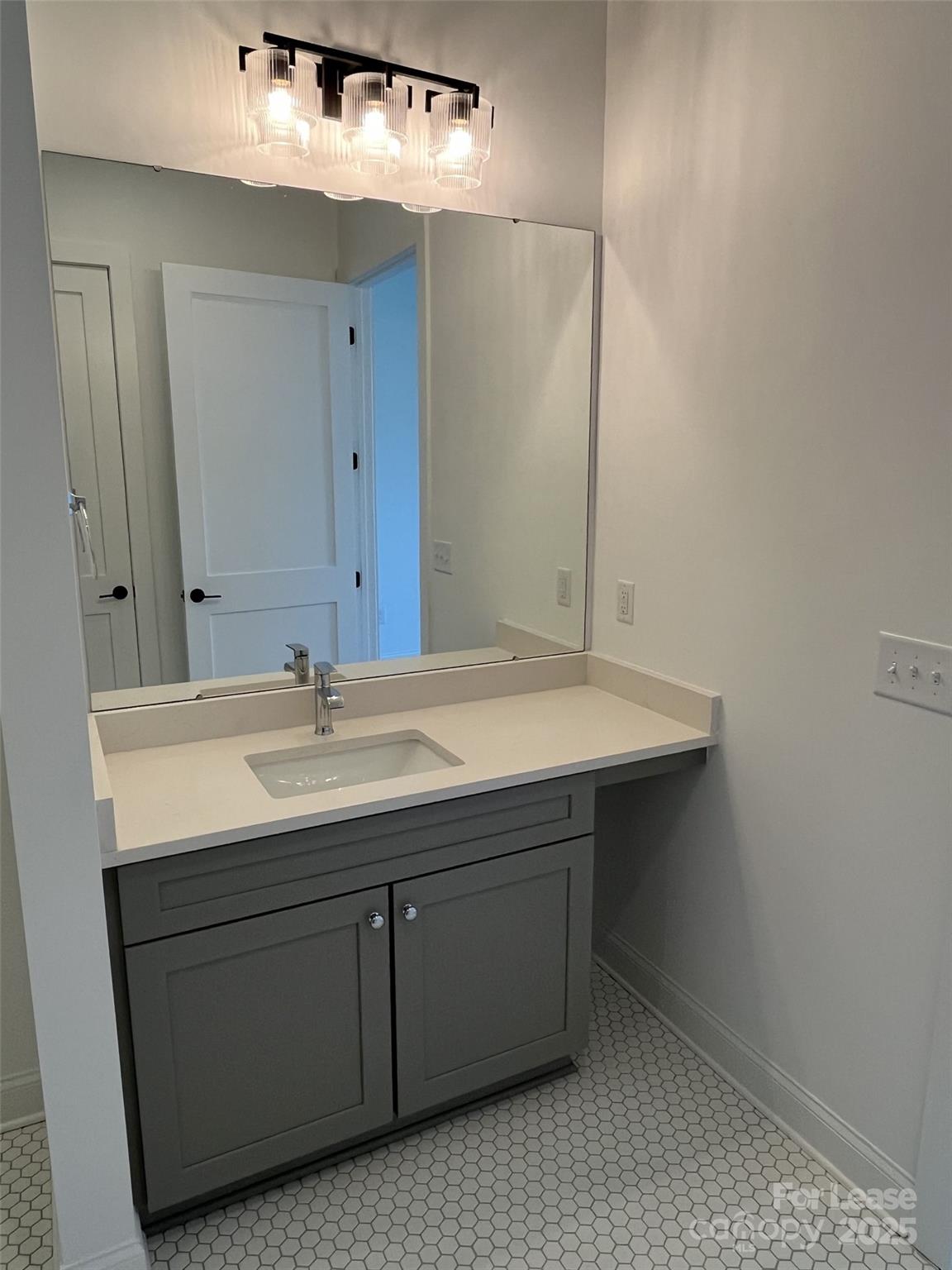 19546 Greentree Way, Unit 202 Cornelius, NC 28031 - Photo 21 of 30 a bathroom with a sink and a mirror