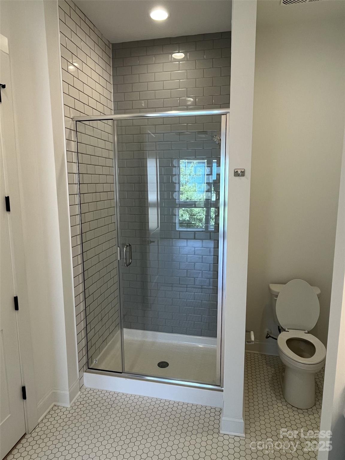 19546 Greentree Way, Unit 202 Cornelius, NC 28031 - Photo 22 of 30 a bathroom with a shower and a toilet