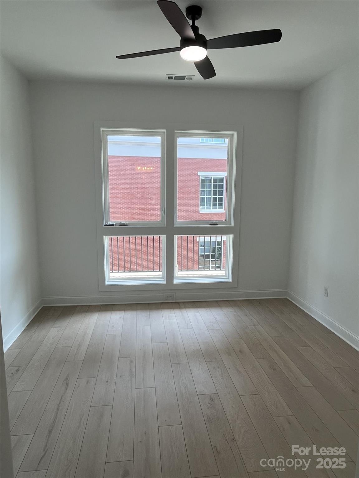 19546 Greentree Way, Unit 202 Cornelius, NC 28031 - Photo 24 of 30 wooden floor in an empty room with a window