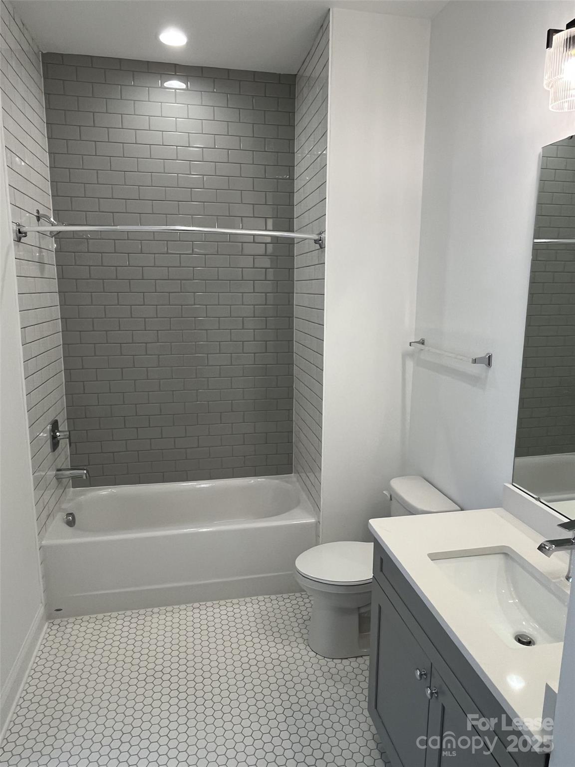 19546 Greentree Way, Unit 202 Cornelius, NC 28031 - Photo 28 of 30 a bathroom with a sink a toilet and shower