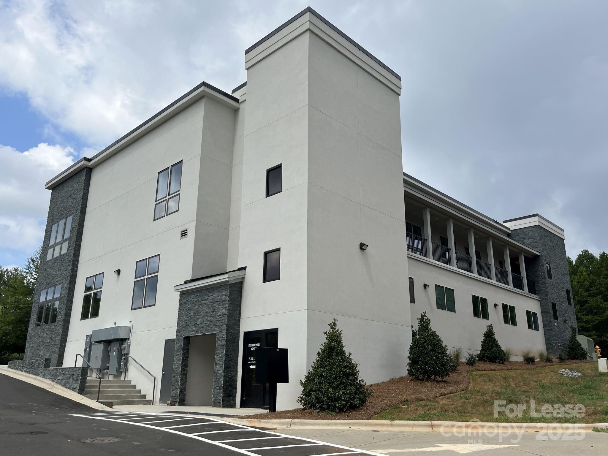 19546 Greentree Way, Unit 202 Cornelius, NC 28031 - Photo 3 of 30 a front view of a house with a yard