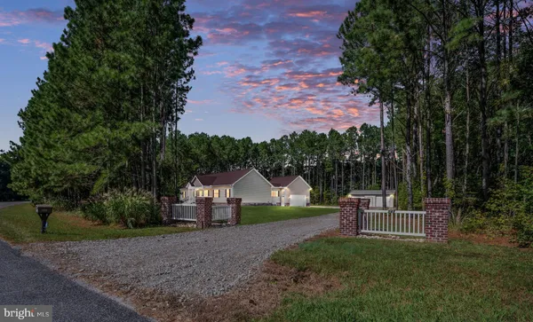 a view of a house with backyard and a sitting area