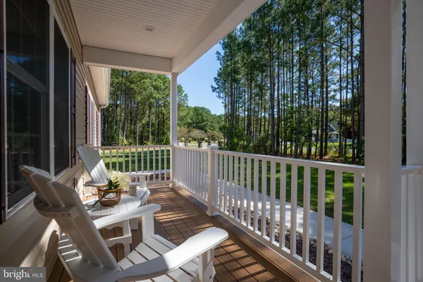 a view of balcony with wooden floor and outdoor seating