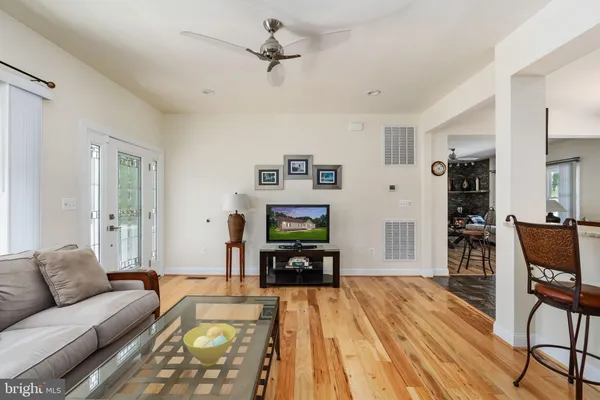 a living room with furniture and a wooden floor