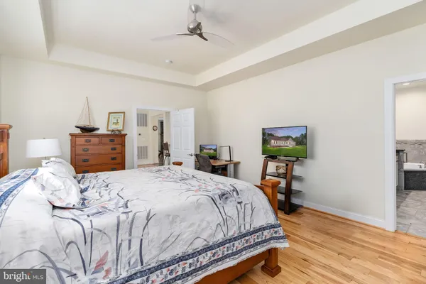 a view of hallway with livingroom and wooden floor