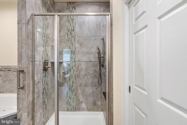 a bathroom with a glass shower door