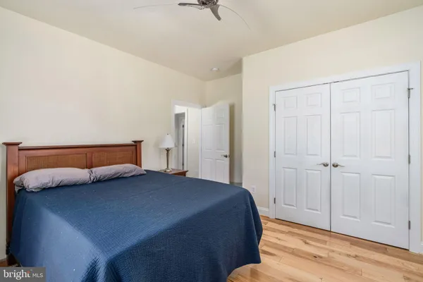 a view of a livingroom with wooden floor and a closet