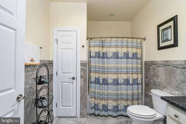 a view of a house with a patio and a yard