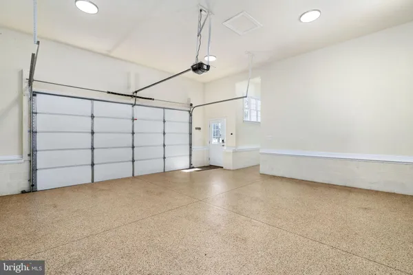 a front view of house with yard and trees in the background