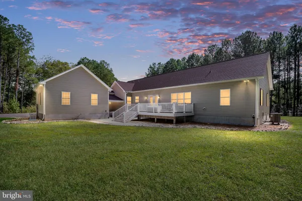 an aerial view of a house with a yard and lake view