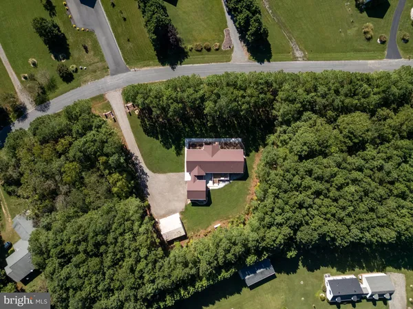 an aerial view of a house with a yard