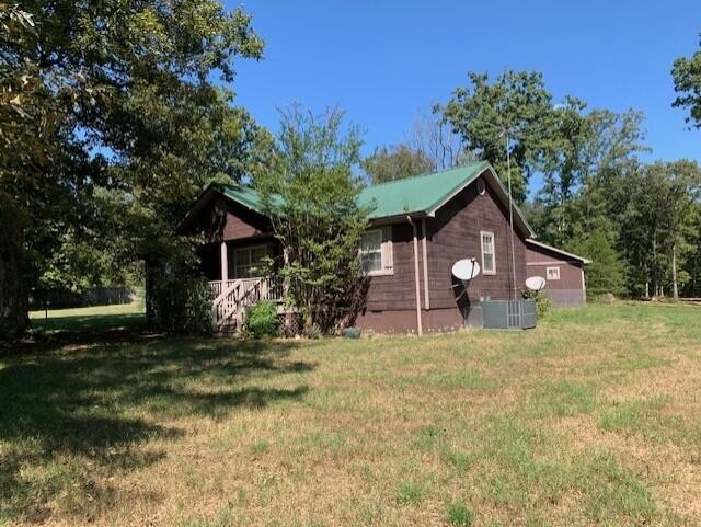 650 Howard Road Decatur, TN 37322 - Photo 3 of 20 a front view of a house with a yard