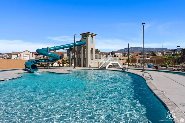 1166 North Riviera Alley Washington, UT 84780 - Photo 1 of 26 Community pool with a water slide and a mountain view