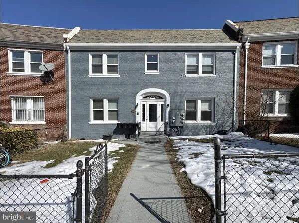 a front view of a house with outdoor seating