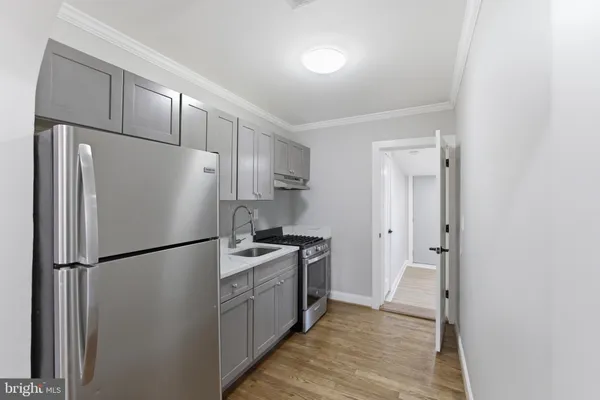 a kitchen with stainless steel appliances a refrigerator and a sink