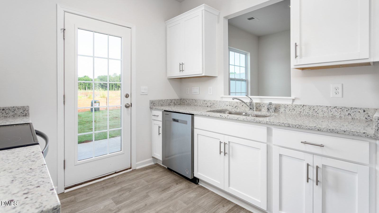 168 Canopy Drive Graham, NC 27253 - Photo 32 of 44 a kitchen with granite countertop white cabinets and a window