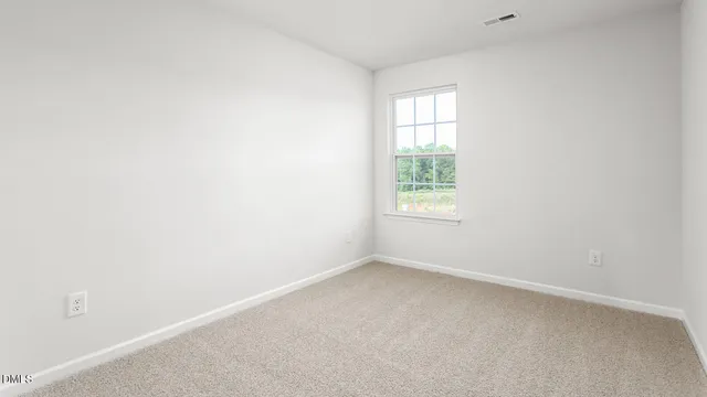 a kitchen with granite countertop white cabinets and a window