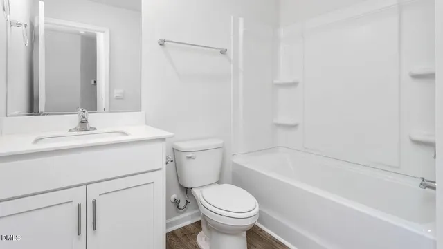 a white toilet sitting next to a white sink