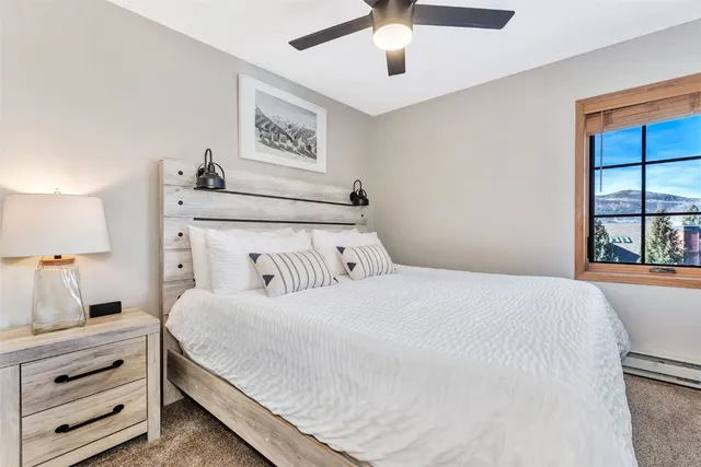 a bedroom with a large bed and a window