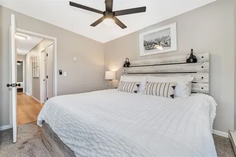 a bedroom with a bed and a painting on the wall