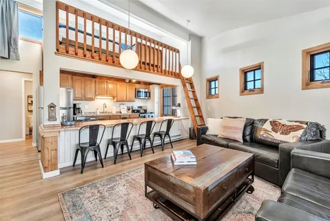 a living room with furniture a window and a table