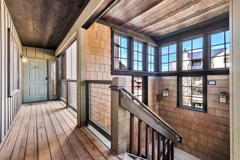 a view of a balcony with wooden floor