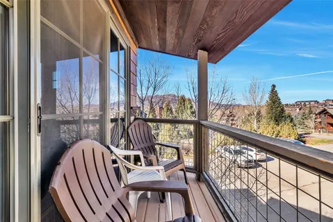 a view of a balcony with chairs
