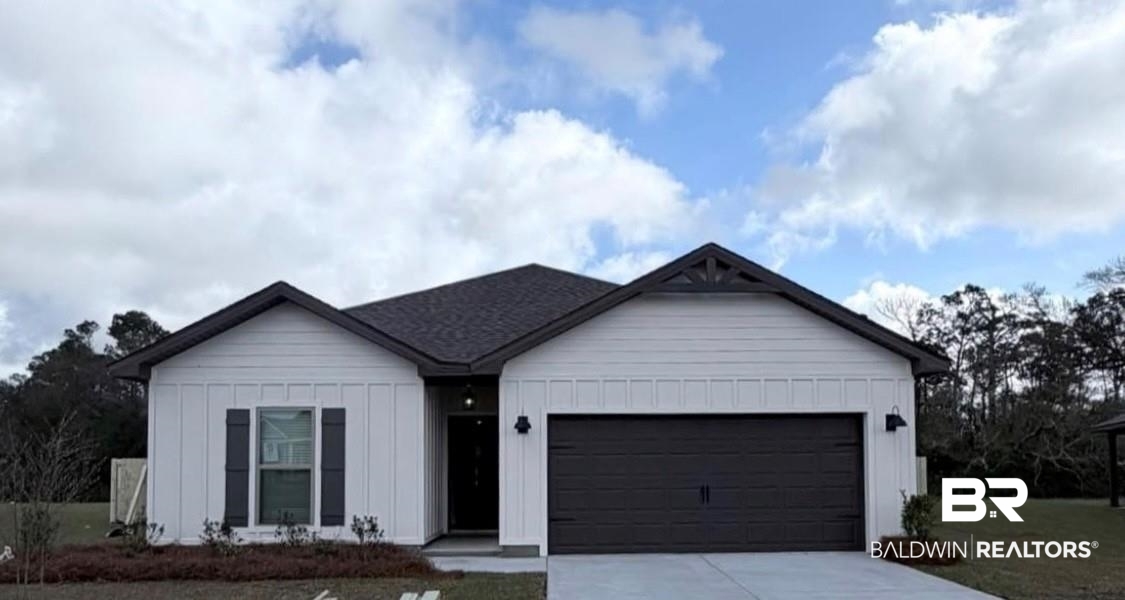 14274 Versailles Circle Silverhill, AL 36576 - Photo 1 of 36 View of front of property featuring a garage, board and batten siding, driveway, and a front yard