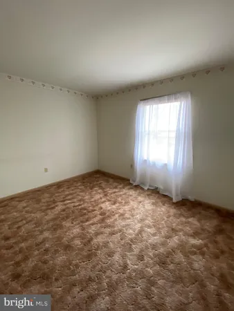 an empty room with a empty space and windows