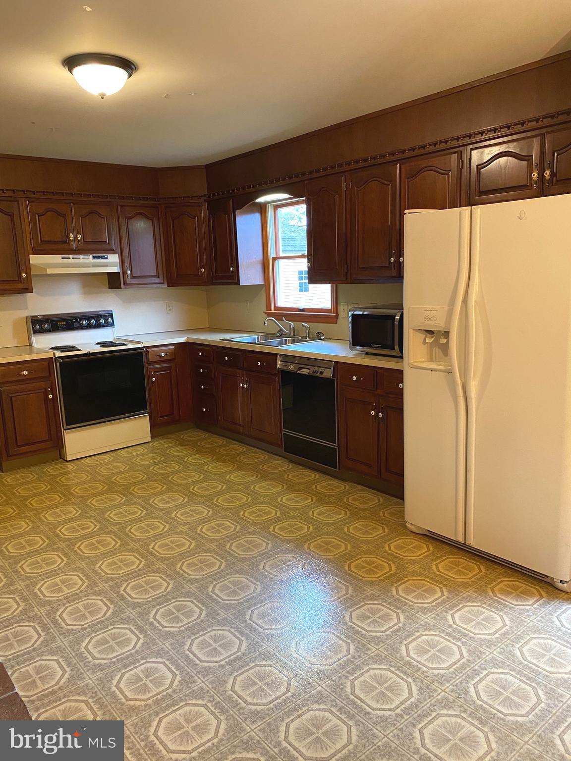 11 Creeks Edge Road Oley, PA 19547 - Photo 9 of 28 a kitchen with stainless steel appliances granite countertop a refrigerator a stove top oven with a sink and dishwasher