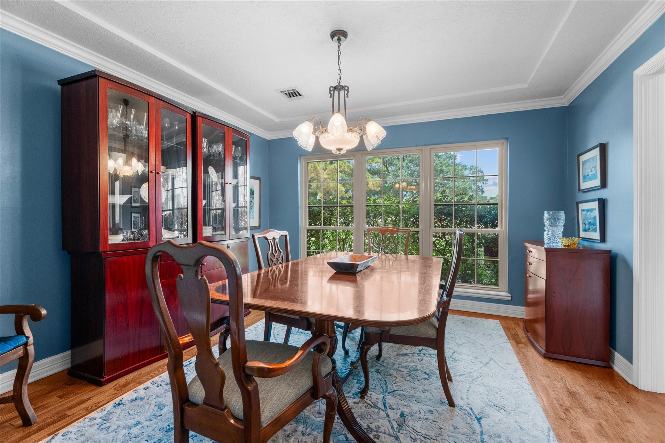 9103 Herts Road Spring, TX 77379 - Photo 12 of 46 The dining room is enhanced with crown molding, a tray ceiling, and a large window lets in abundant natural light.