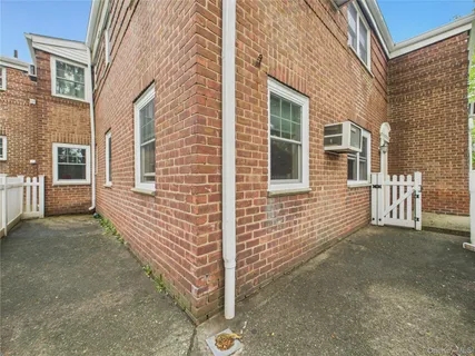 a view of a brick house with many windows