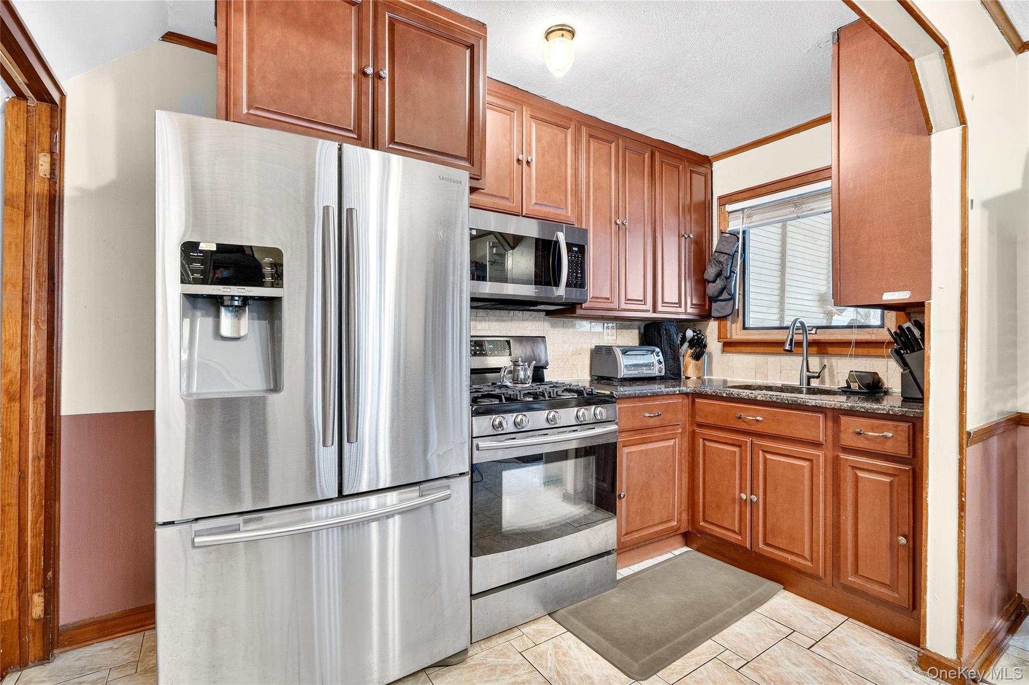 3062 Harding Avenue Bronx, NY 10465 - Photo 17 of 34 a kitchen with stainless steel appliances granite countertop a refrigerator stove top oven and sink