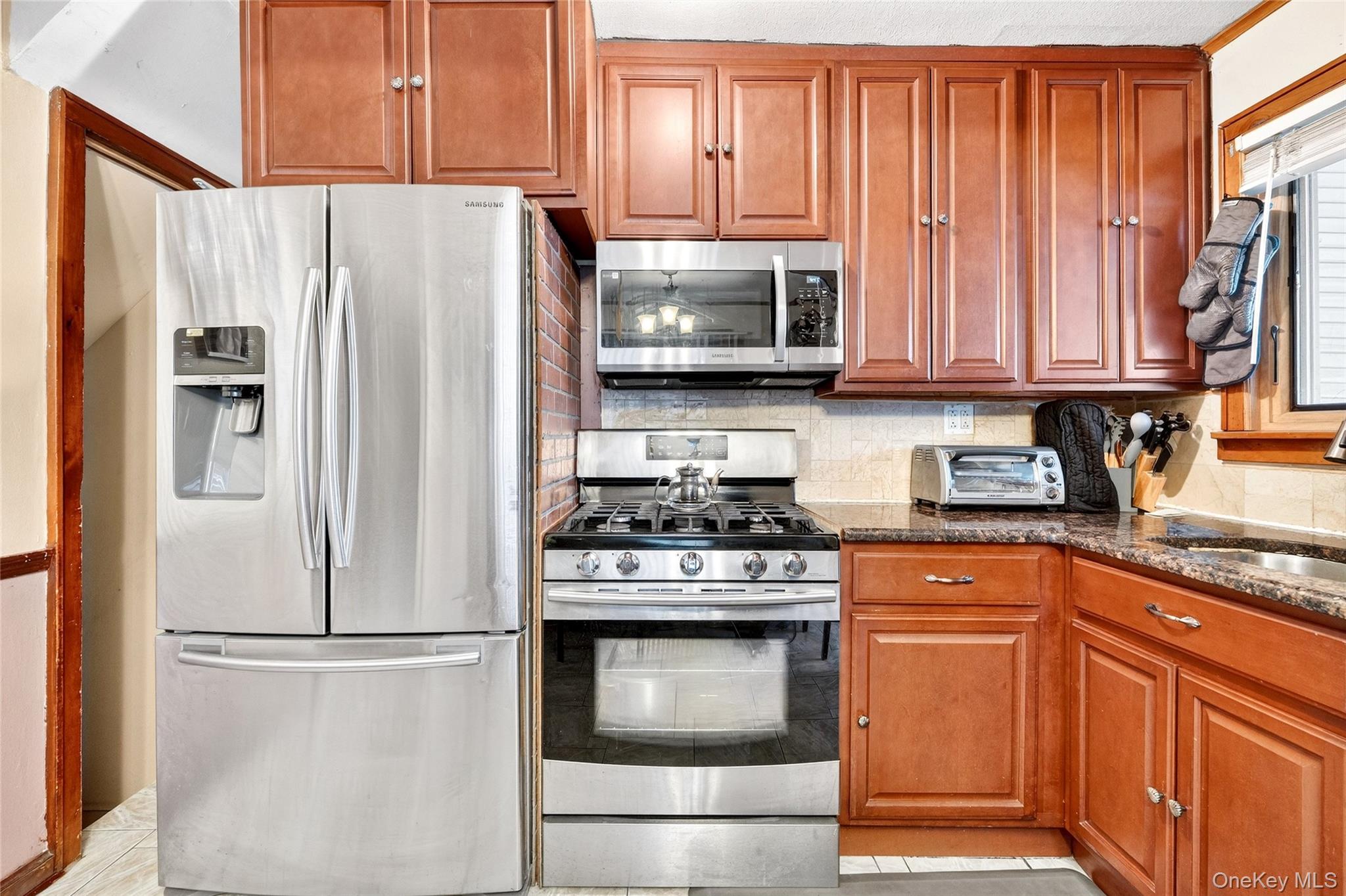 3062 Harding Avenue Bronx, NY 10465 - Photo 18 of 34 a kitchen with granite countertop a refrigerator stove and microwave