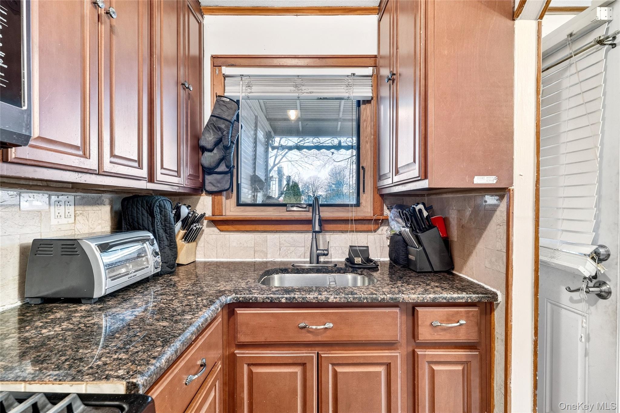3062 Harding Avenue Bronx, NY 10465 - Photo 19 of 34 a kitchen with granite countertop a sink and a window