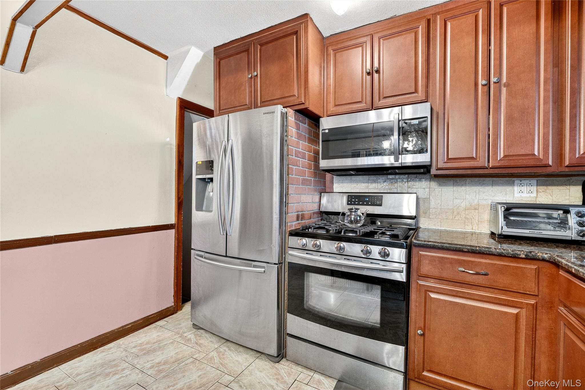 3062 Harding Avenue Bronx, NY 10465 - Photo 20 of 34 a kitchen with granite countertop wooden cabinets stainless steel appliances and a window