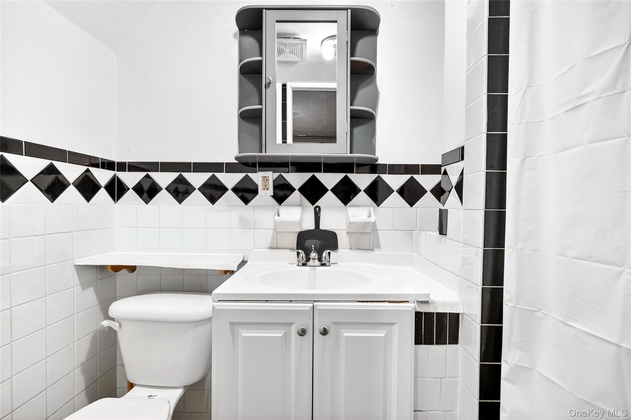 3062 Harding Avenue Bronx, NY 10465 - Photo 27 of 34 a bathroom with a sink and a toilet