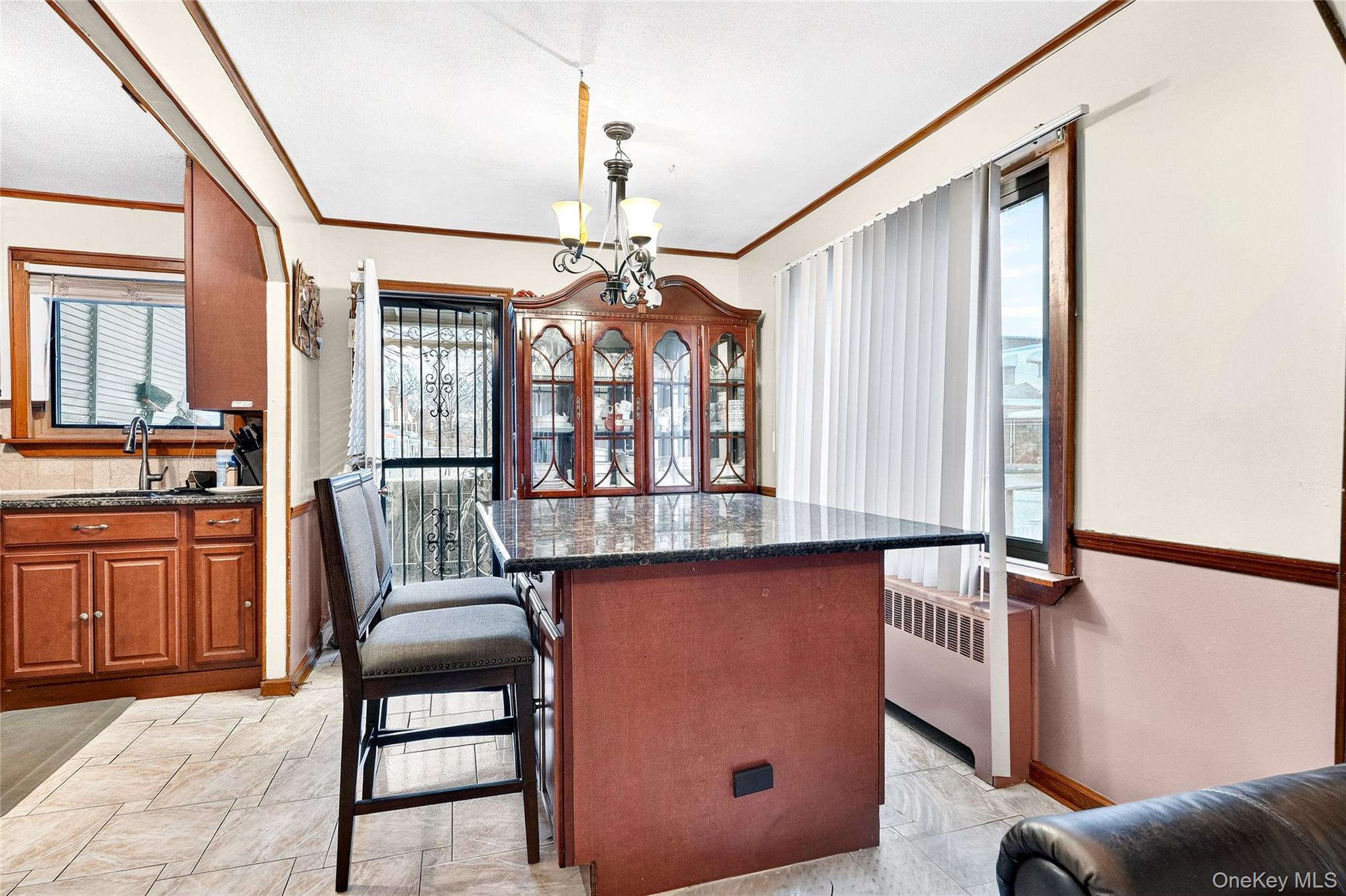 3062 Harding Avenue Bronx, NY 10465 - Photo 6 of 34 a view of a kitchen with granite countertop a table chairs and a wooden floor