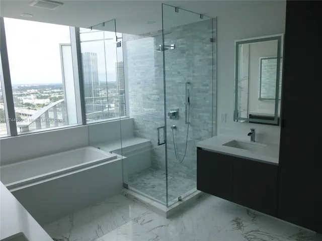 a bathroom with a shower and a sink