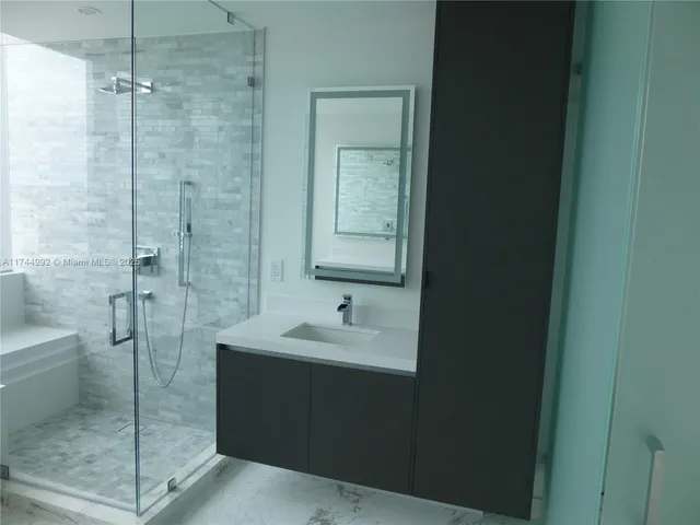 a bathroom with a sink and mirror