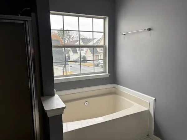 a bath tub sitting next to a window