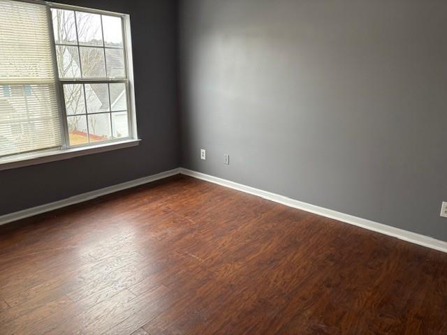 408 Spring Head Drive Southeast Lawrenceville, GA 30046 - Photo 10 of 10 an empty room with wooden floor and windows