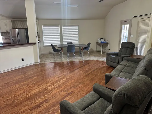 a kitchen with stainless steel appliances granite countertop a sink refrigerator stove and microwave