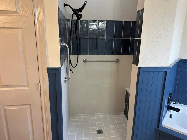 a bathroom with a bathtub and a shower