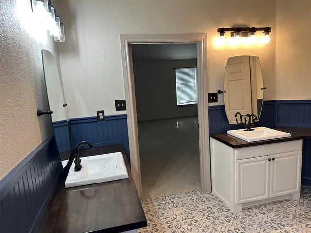 a bathroom with a sink a toilet and mirror