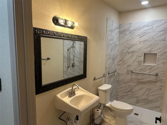 a kitchen with kitchen island granite countertop a stove refrigerator and cabinets