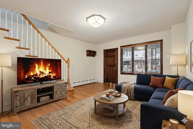 a living room with furniture a flat screen tv and a fireplace