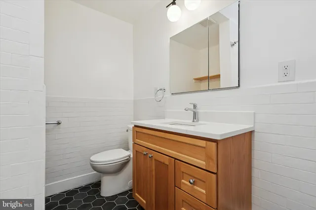 a bathroom with a sink toilet and vanity